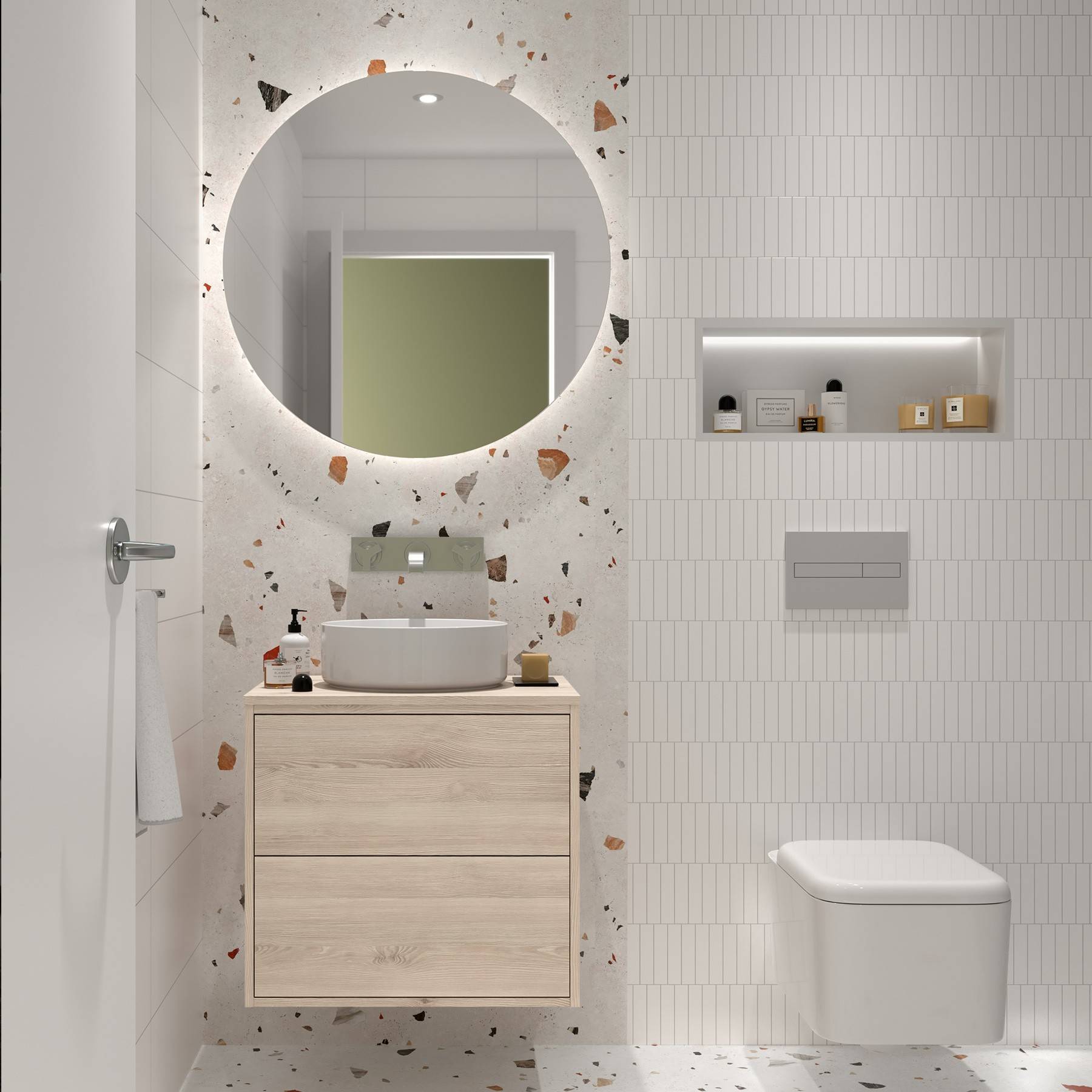 Ein modernes Badezimmer mit weißem und Terrazzo-Design verfügt über einen runden Spiegel, ein wandmontiertes Waschbecken und ein eingelassenes Regal über der Toilette.