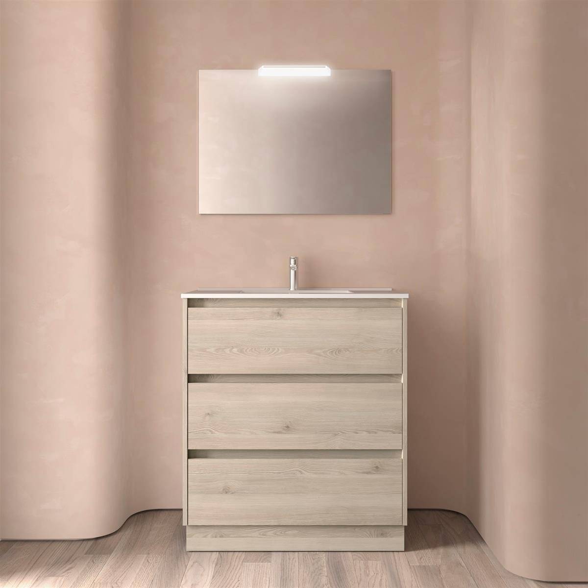 Minimalistische Badezimmerkommode mit Waschbecken und drei Schubladen unter einem Spiegel, zentriert an beigefarbenen gekrümmten Wänden und Holzboden.