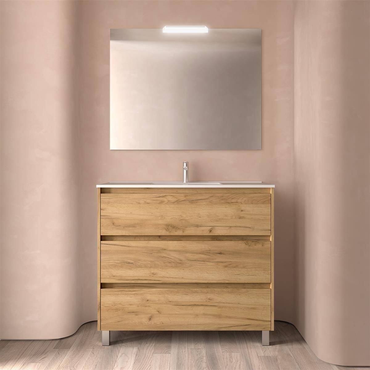 Modernes Badezimmermöbel mit Holzschubladen, Waschbecken und rechteckigem Spiegel unter einer Leuchte, vor weichen beigefarbenen Wänden.