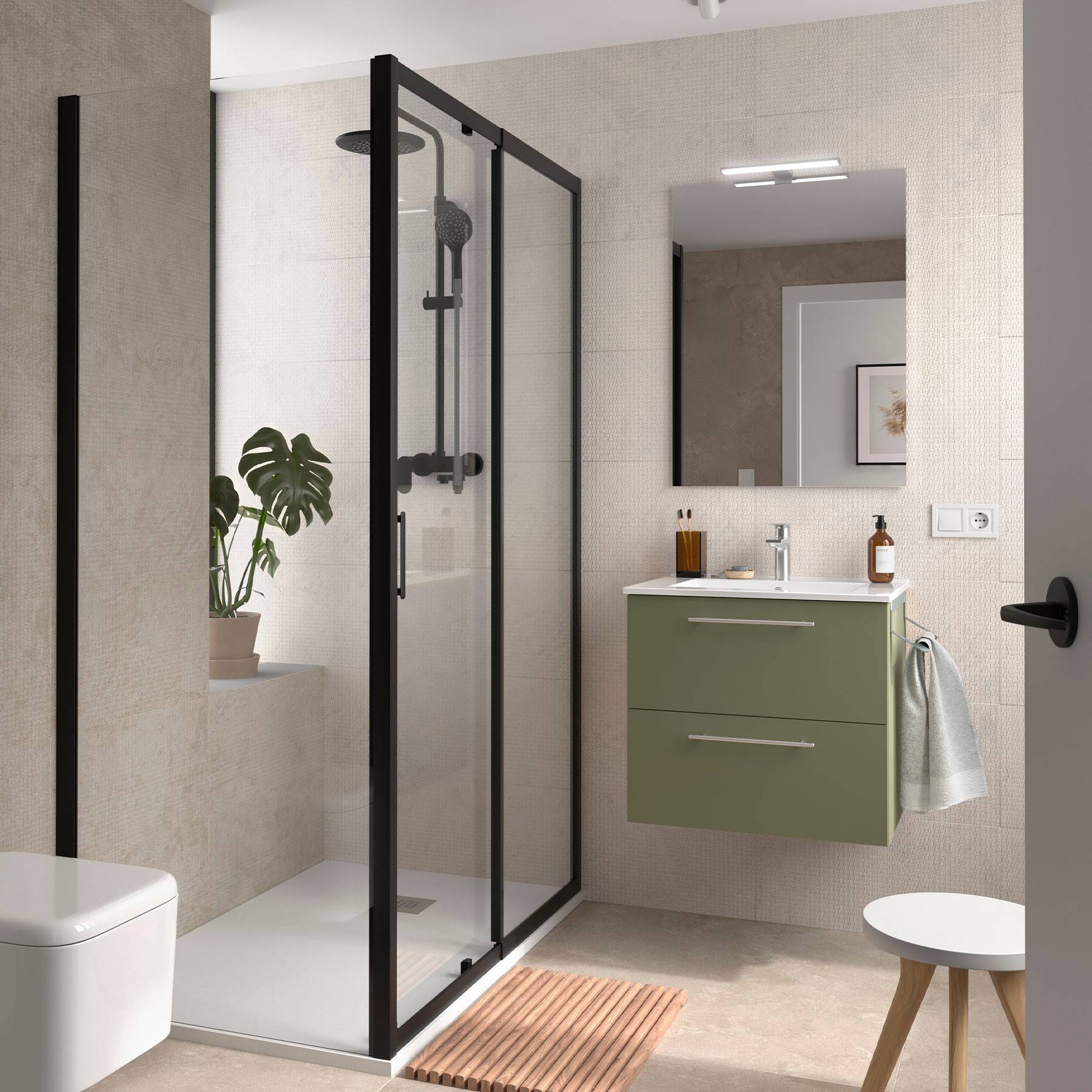 Modernes Badezimmer mit einer Duscheinfassung aus Glas, grüner Waschtisch mit einem Spiegel und einer Topfpflanze. Neutrale Töne und elegante Armaturen.