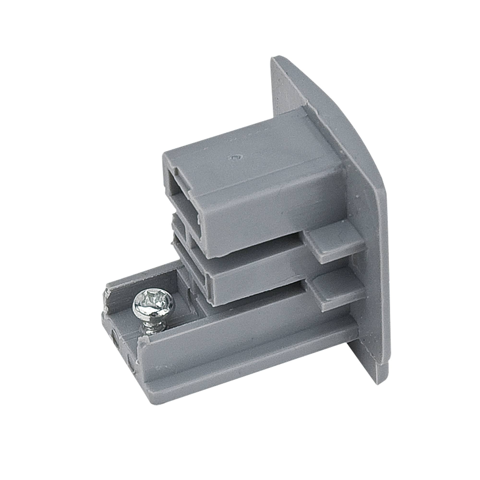 Ein graues Plastikverbindungsstück mit einer einzelnen angebrachten Schraube, wahrscheinlich zum Verbinden von Strukturkomponenten oder zur Möbelmontage verwendet.