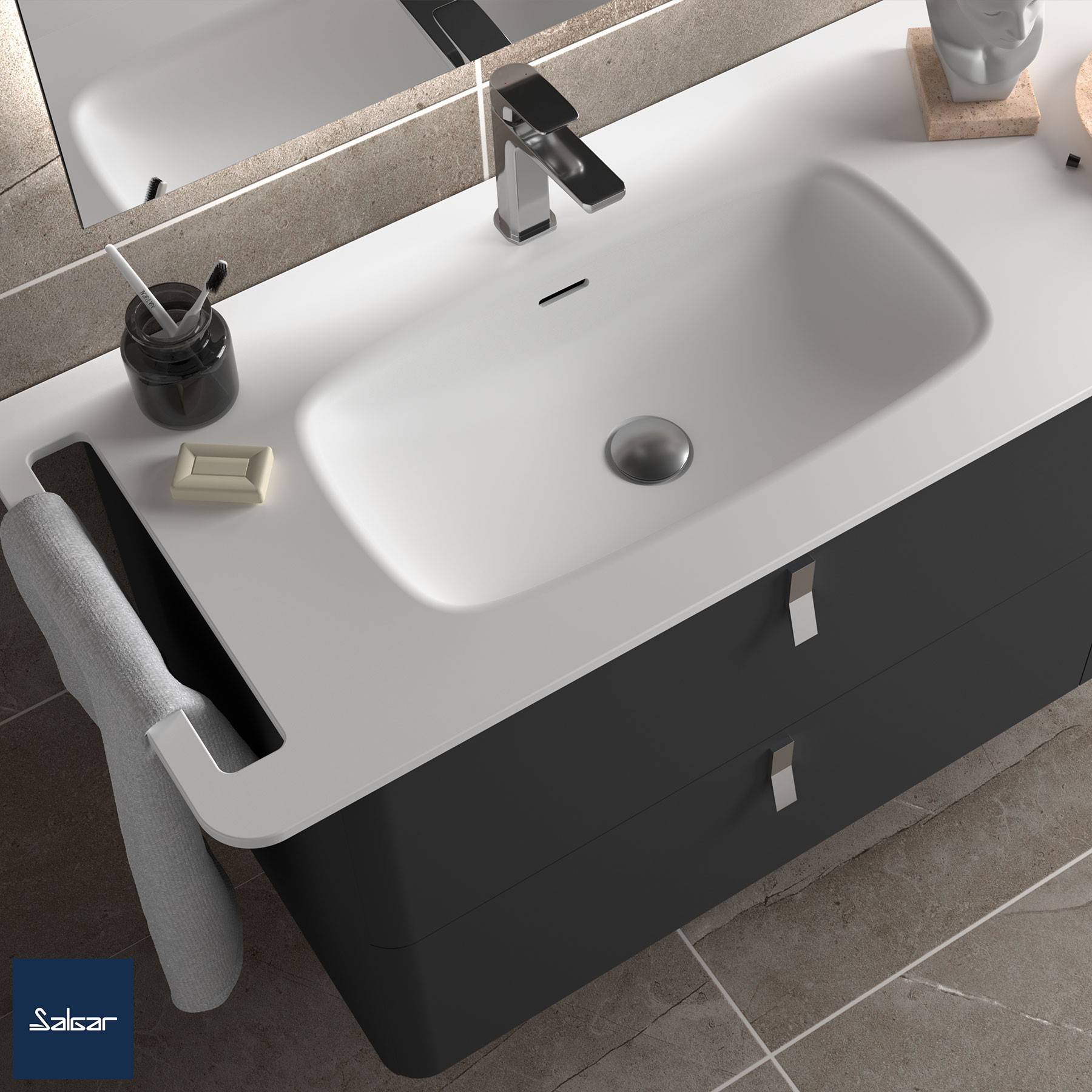 Ein modernes Waschbecken mit weißer Arbeitsplatte, einem einzelnen Wasserhahn und schwarzer Basis. Ein Seifenspender, eine Seifenschale und ein Handtuch befinden sich in der Nähe.