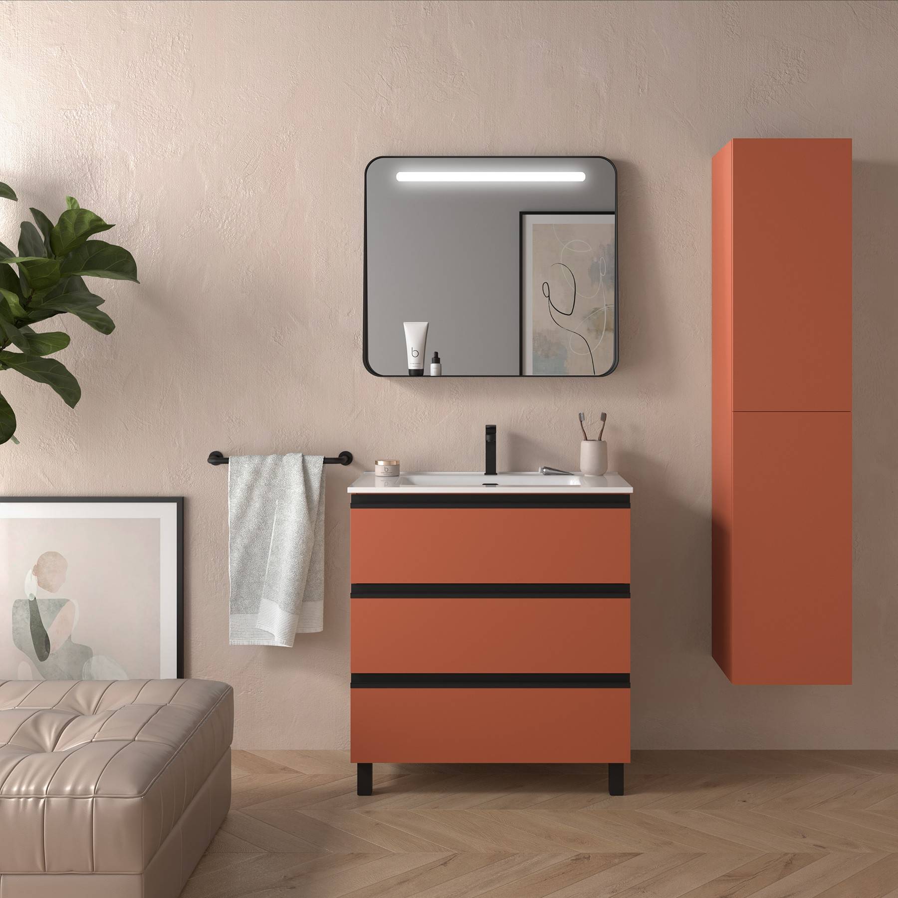 Ein modernes Badezimmer mit einer Terrakotta-Waschtischplatte, rundem Spiegel und minimalistischer Dekoration. Ein Handtuch hängt neben einer Topfpflanze und gerahmter Kunstarbeit.