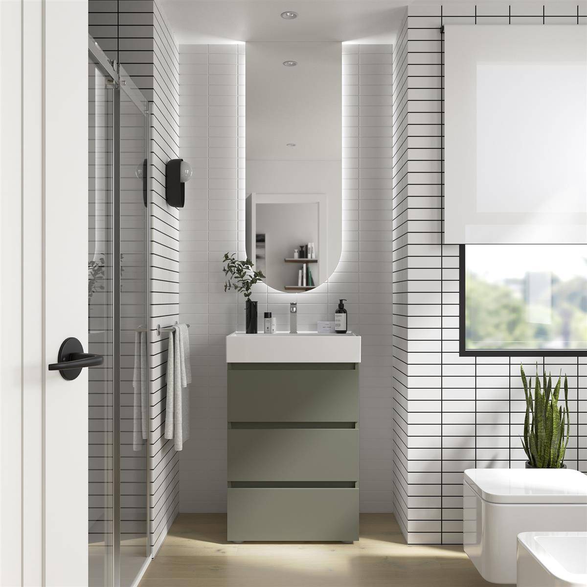 Modernes Badezimmer mit Glasdusche auf der linken Seite, schwebendem Waschtisch und ovalem Spiegel in der Mitte, geflieste Wände, Fenster und Toilette auf der rechten Seite sowie eine Topfpflanze.