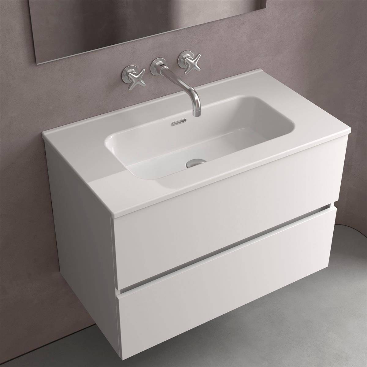 Modernes weißes wandmontiertes Badezimmer-Waschtisch mit integriertem Waschbecken und Chromarmatur vor einer grauen Wand.