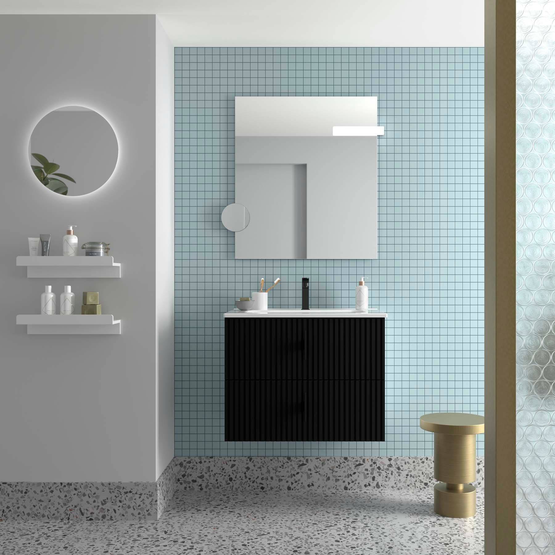 Ein modernes Badezimmer mit einem kreisförmigen Spiegel, schwebenden Regalen mit Toilettenartikeln, einem Waschbecken mit einem schwarzen Schrank und einer blauen gefliesten Wand.