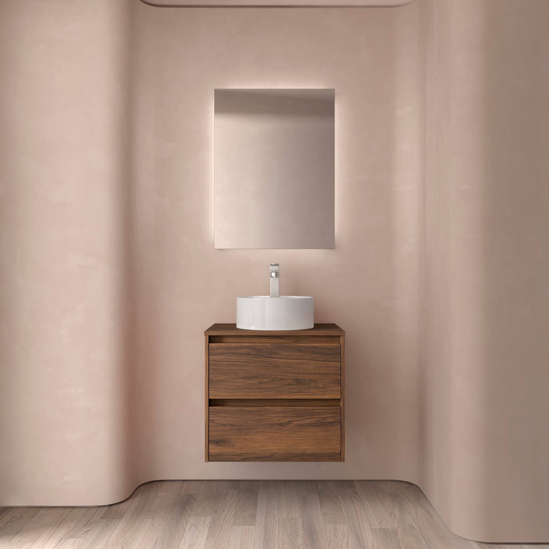 Ein minimalistisches Badezimmer zeigt einen Waschtisch aus Holz mit zwei Schubladen, der von einem runden weißen Waschbecken und Wasserhahn gekrönt wird, vor einer geschwungenen rosa Wand.