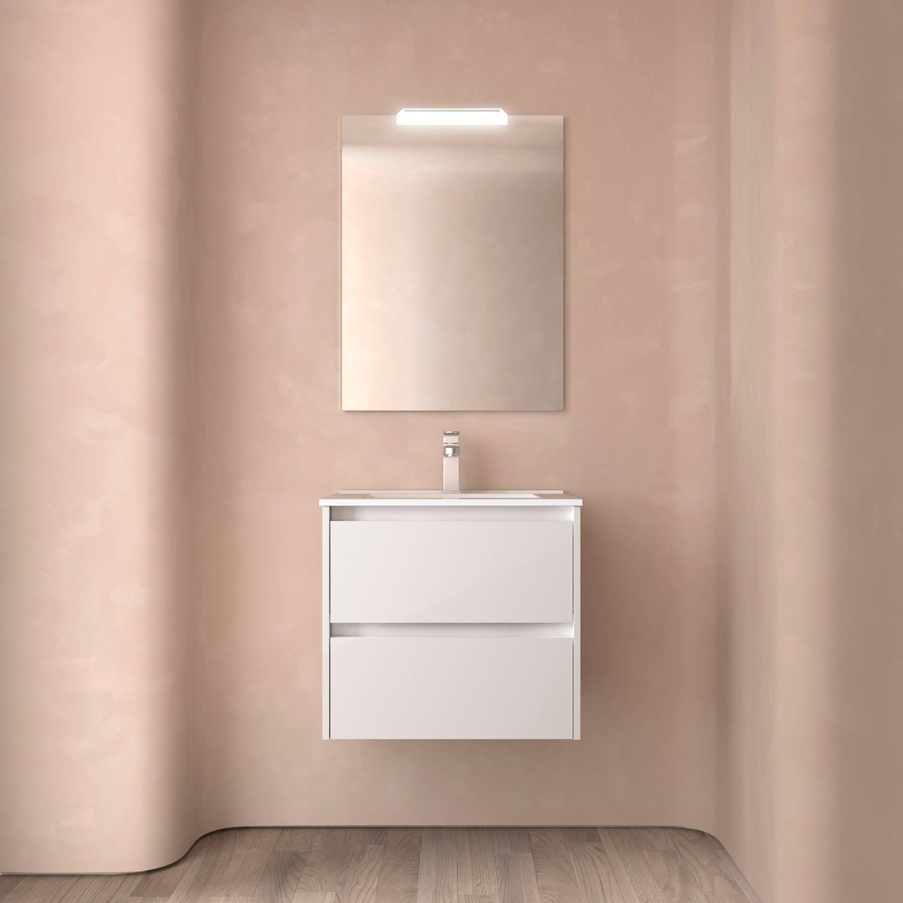 Ein minimalistisches Badezimmer mit einer hellgefärbten Wand zeigt einen weißen Waschtisch mit zwei Schubladen, einen schlichten Wasserhahn und einen rechteckigen Spiegel.