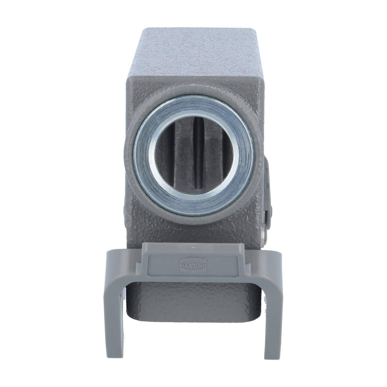 Rechteckiger grauer Metallblock mit einem kreisförmigen Loch an der Vorderseite und einer geformten Klemme an der Basis, möglicherweise Teil einer mechanischen Baugruppe.