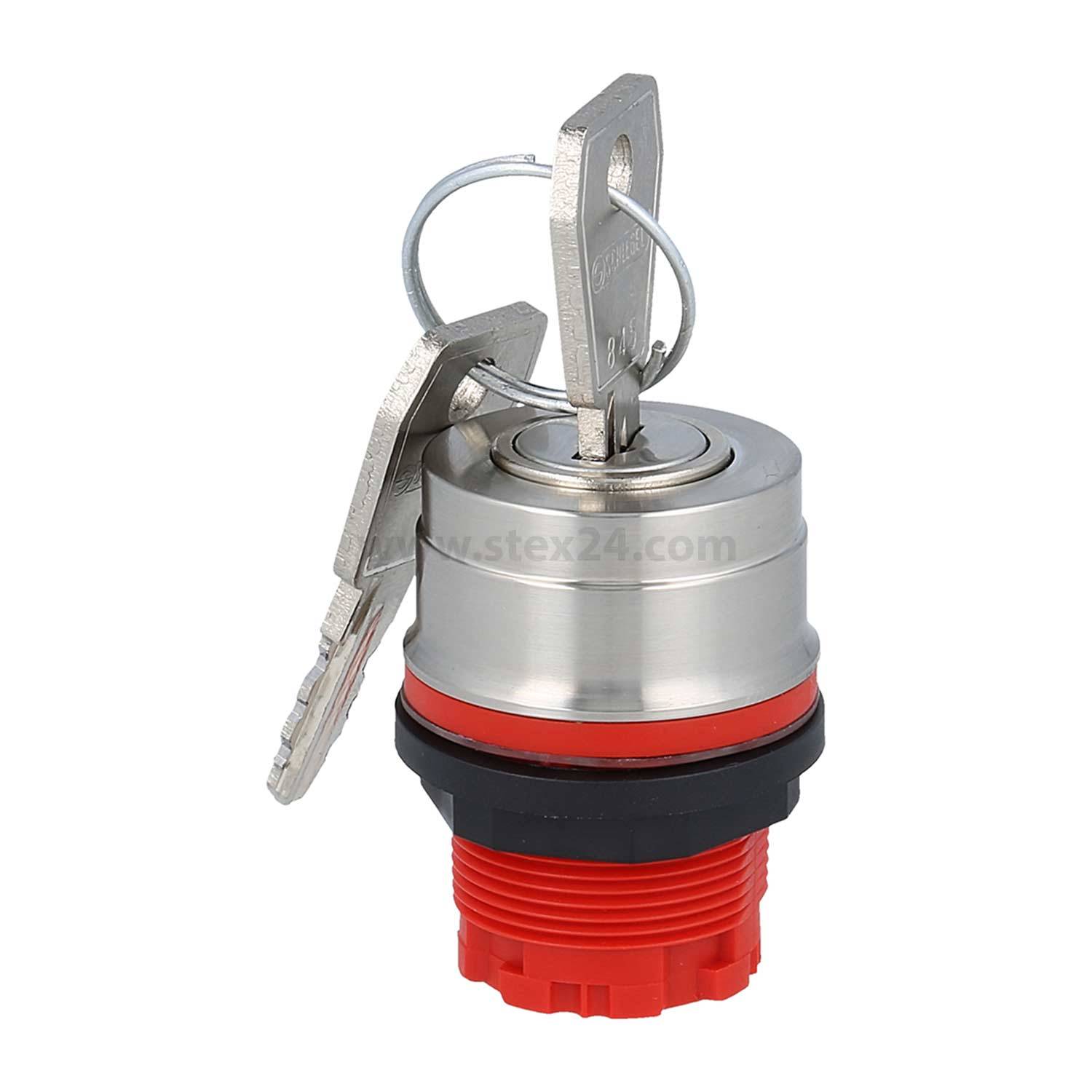 Ein Metallschlosszylinder mit zwei angehängten Schlüsseln und einer roten Basis sitzt aufrecht und zeigt ein kreisförmiges Design mit einem Schlüsselloch auf der Oberseite.