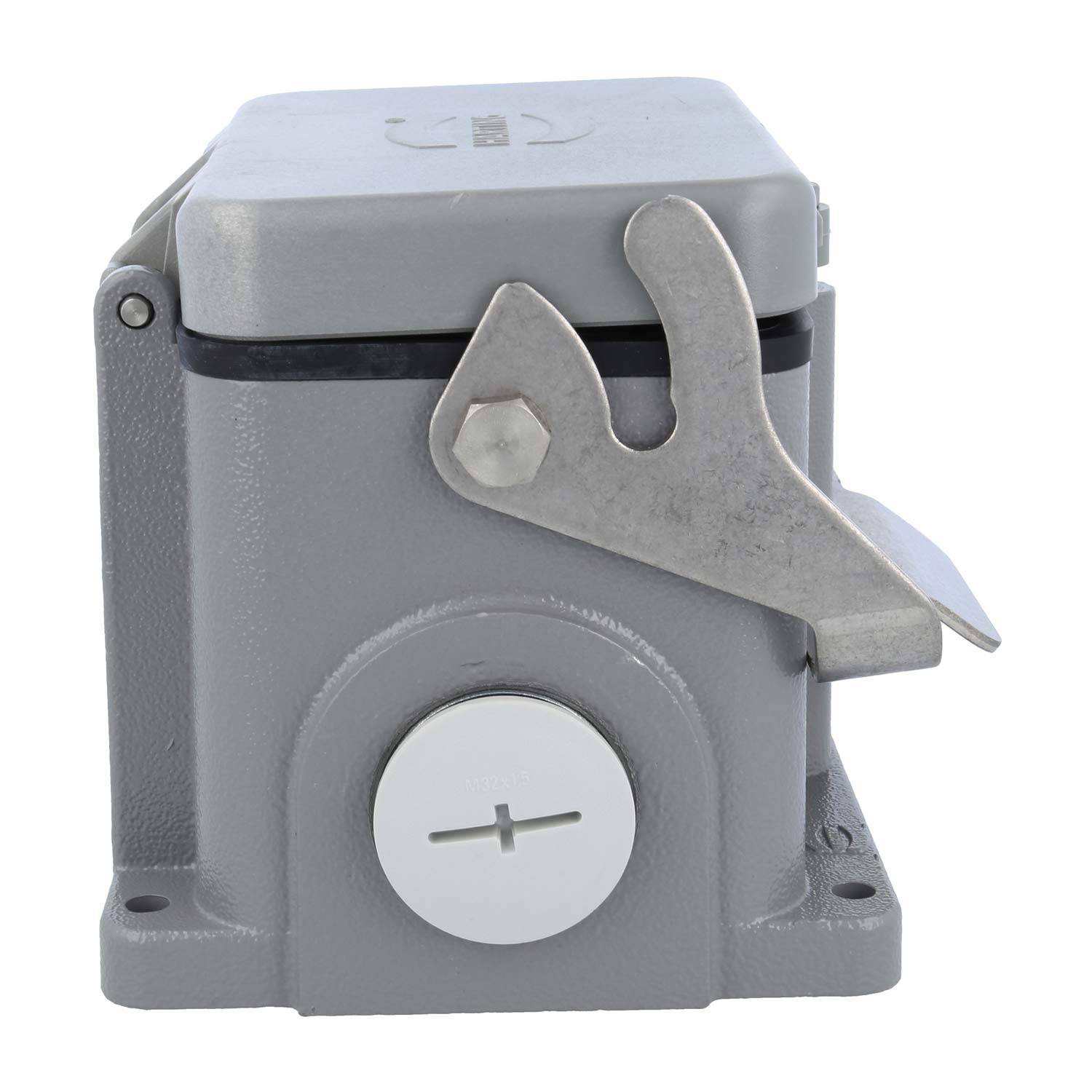 Ein grauer, metallischer, kastenförmiger Gegenstand mit einem Hebel oben und einem Pluszeichen auf der Vorderseite, was auf eine mechanische oder elektrische Komponente hindeutet.