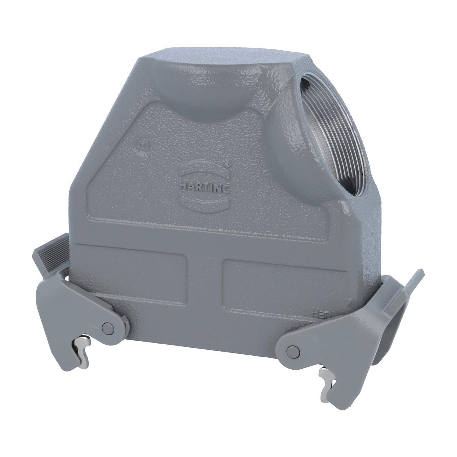 Eine graue, metallische industrielle Anschlusshaube mit seitlichen Verriegelungen und einer verschraubbaren Öffnung an der Oberseite für eine sichere Befestigung an einer Montagebasis.