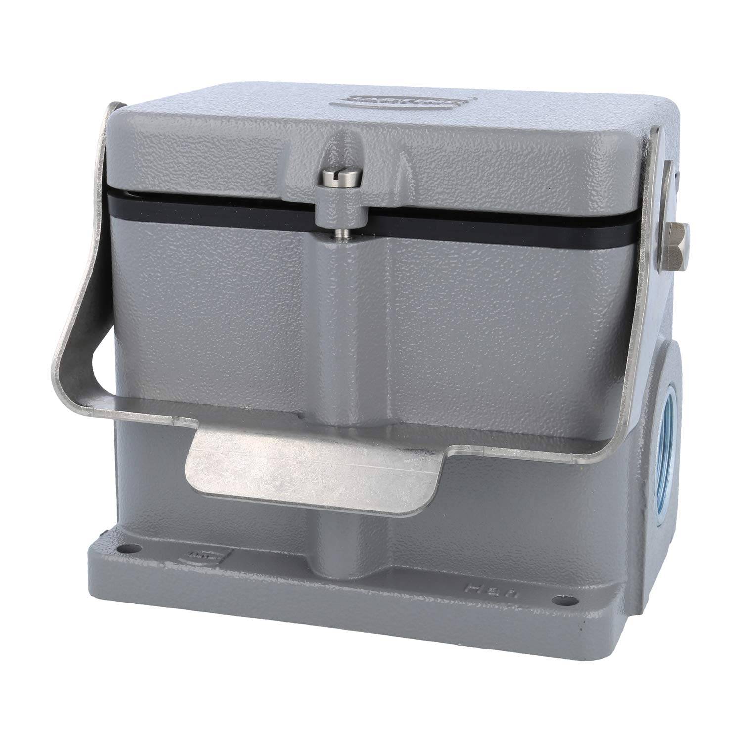 Graue quadratische industrielle Maschinenkomponente mit einer Klappabdeckung und einem Metallhebel an der Seite, die auf einer Basis mit Befestigungslöchern ruht.