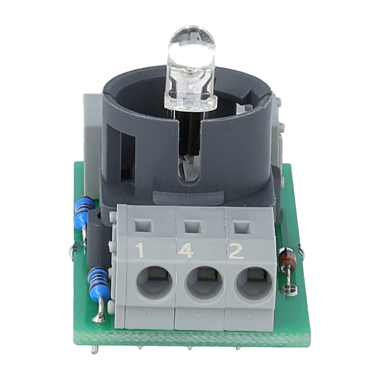 Eine elektronische Komponente mit einer klaren LED-Leuchte, die in einer grauen Fassung auf einer kleinen grünen Leiterplatte mit nummerierten Anschlüssen sitzt.