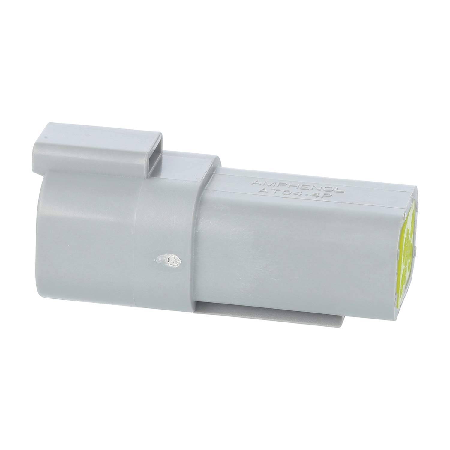 Ein grauer elektrischer Stecker, zylindrisch geformt, mit einer flachen Oberseite und einer sichtbaren Innenstruktur.