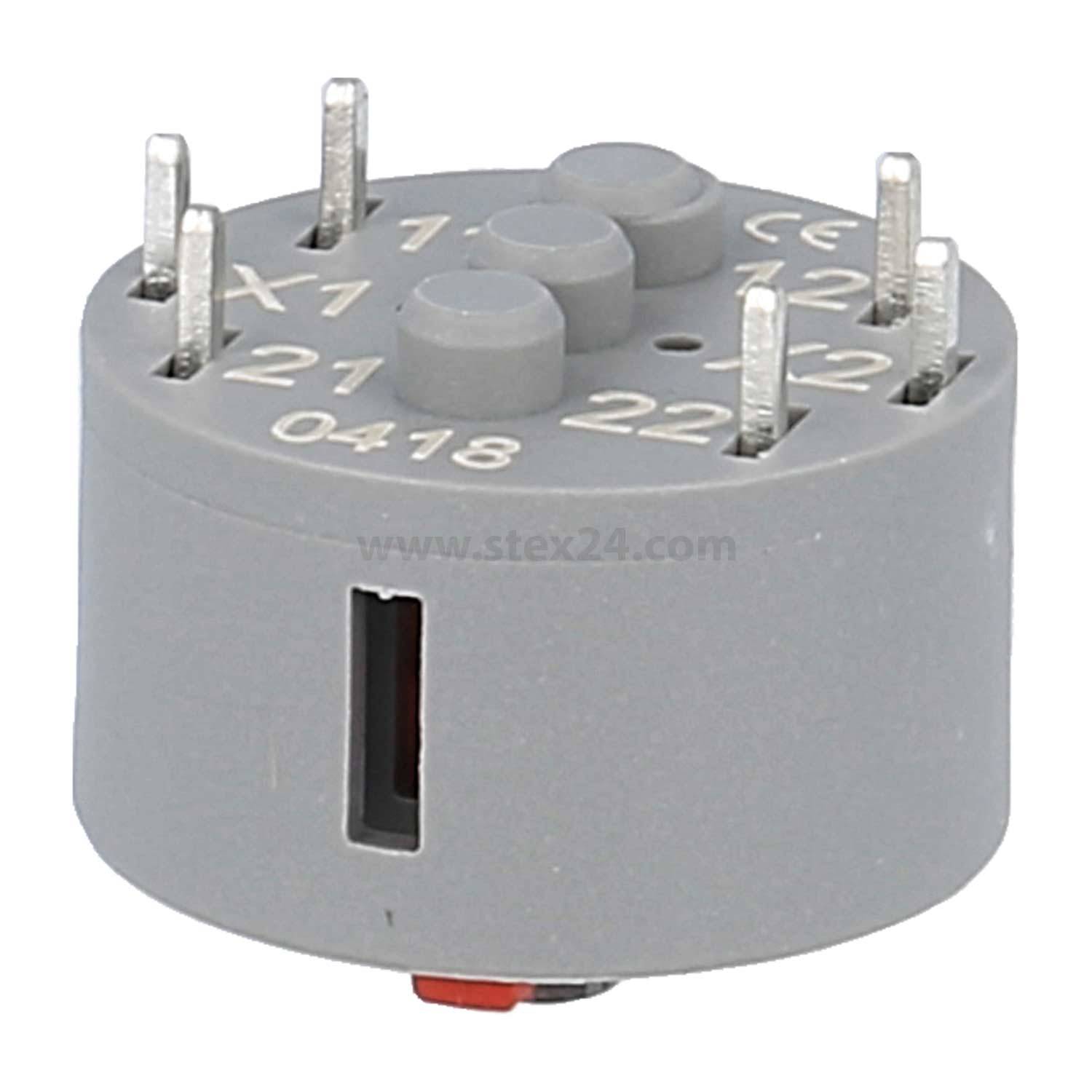 Eine graue kreisförmige elektronische Komponente mit beschrifteten Metallstiften: 'X1', 'X2', '12', '22' und weiteren; verwendet für elektrische Verbindungen.