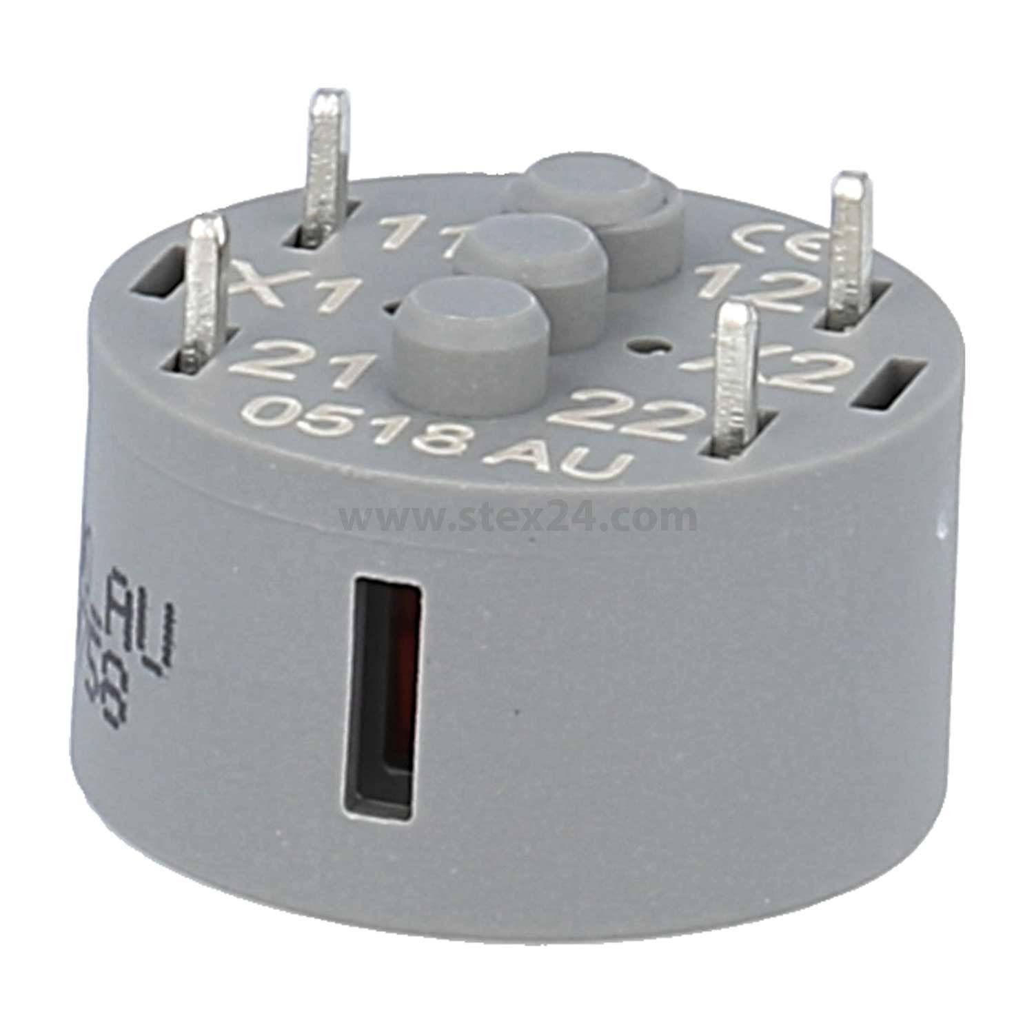 Graue elektrische Komponente mit mehreren Metallstiften und beschrifteter Nummerierung, möglicherweise ein Relais oder eine Anschlussbase, zum Anbringen konzipiert.