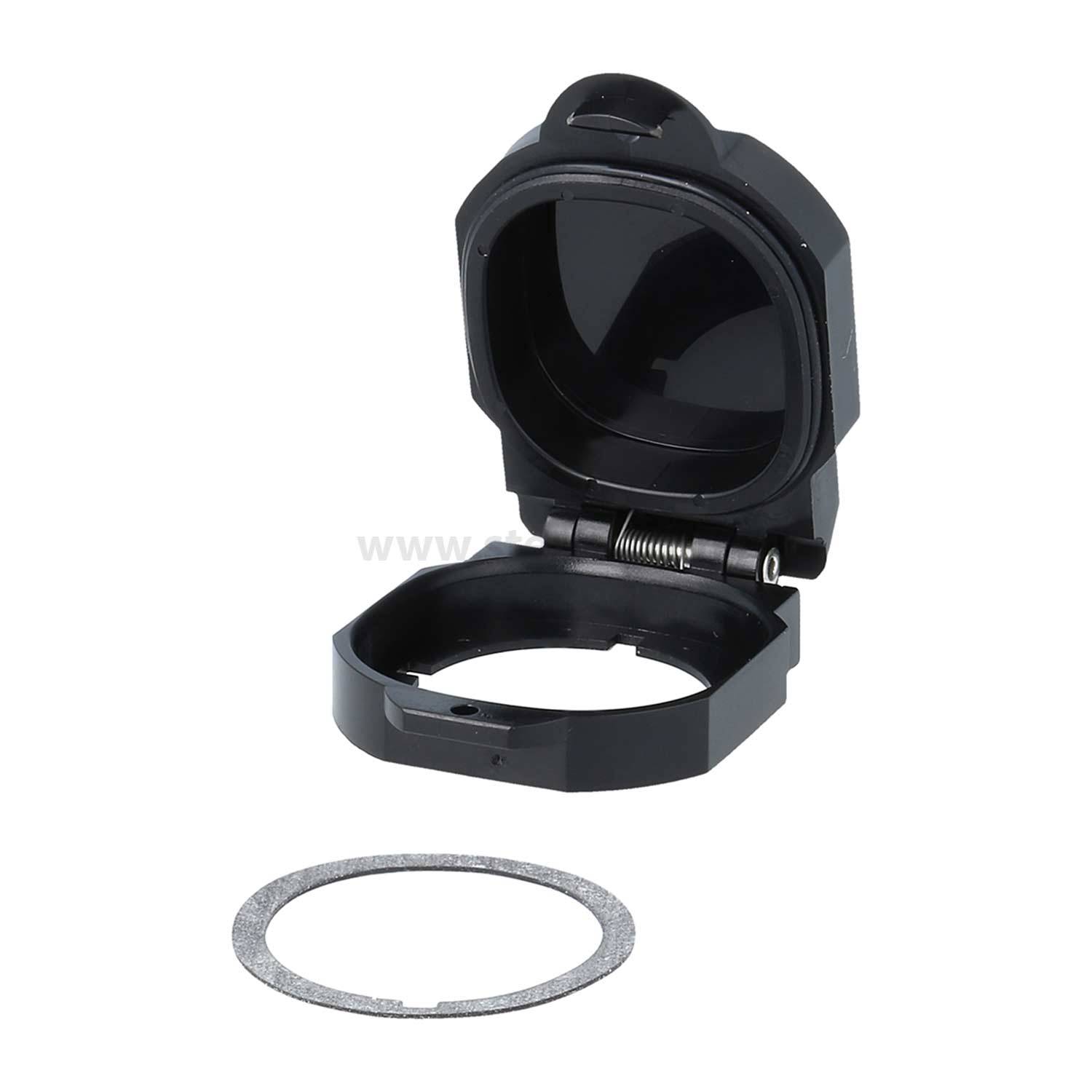 Ein runder schwarzer Gegenstand mit einem Klappdeckel, geöffnet, um ein kreisförmiges Fach zu offenbaren, und ein separater grauer Ring, der daneben liegt.