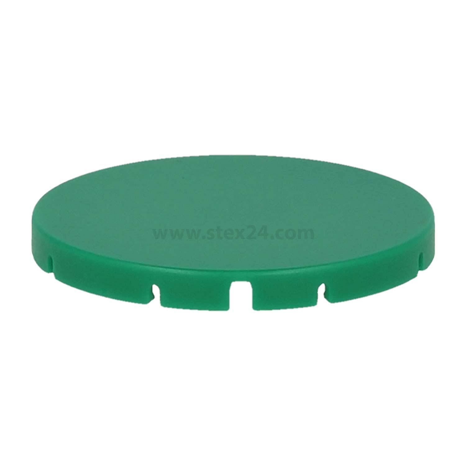 Eine runde, flache grüne Scheibe mit kleinen Einschnitten entlang des Randes, die dezenten Text in der Mitte aufweist.