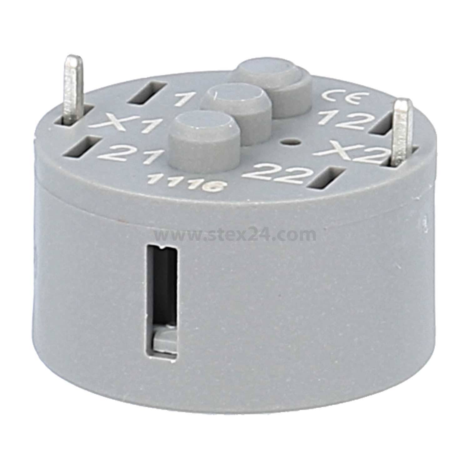 Eine graue, zylindrische elektronische Buchse mit vier Metallstiften und beschrifteten Schlitzen: 'X1', 'X2', '21', '22'.