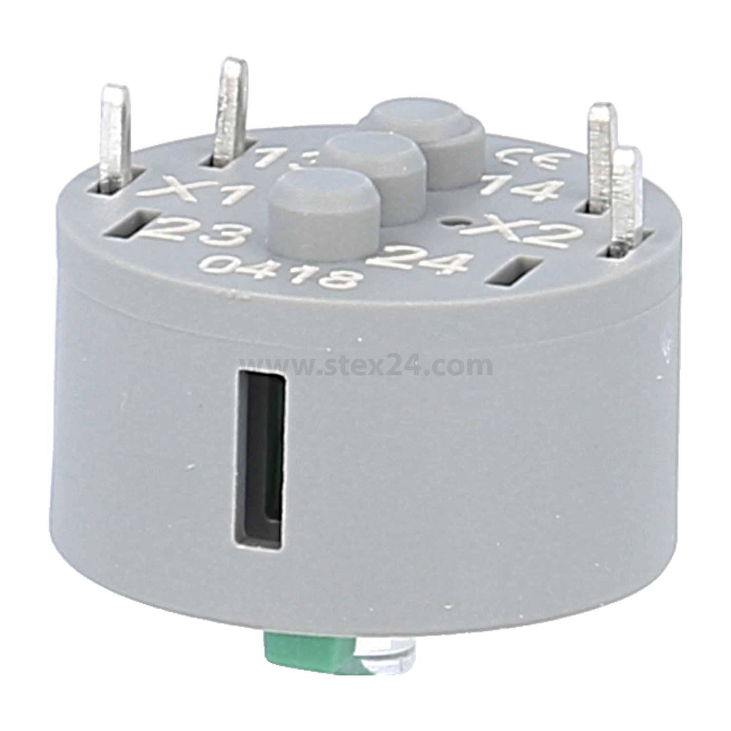 Eine runde, graue elektronische Komponente mit mehreren Metallstiften, beschriftet mit Zahlen und Buchstaben wie 