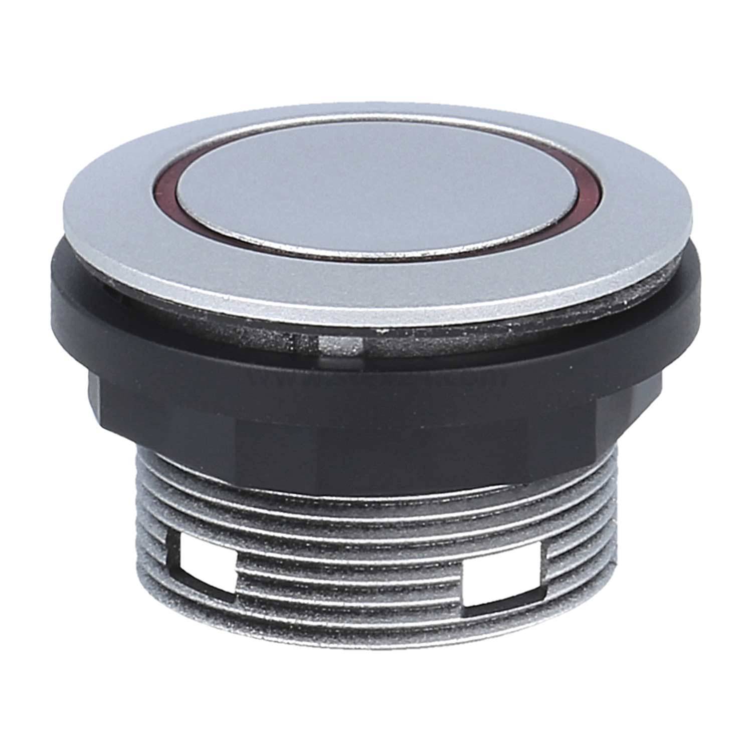 Ein kreisförmiger metallischer Drucktastenschalter mit silberner Oberseite und schwarzem Sockel, konzipiert für die Montage auf elektronischen Bedienblenden.