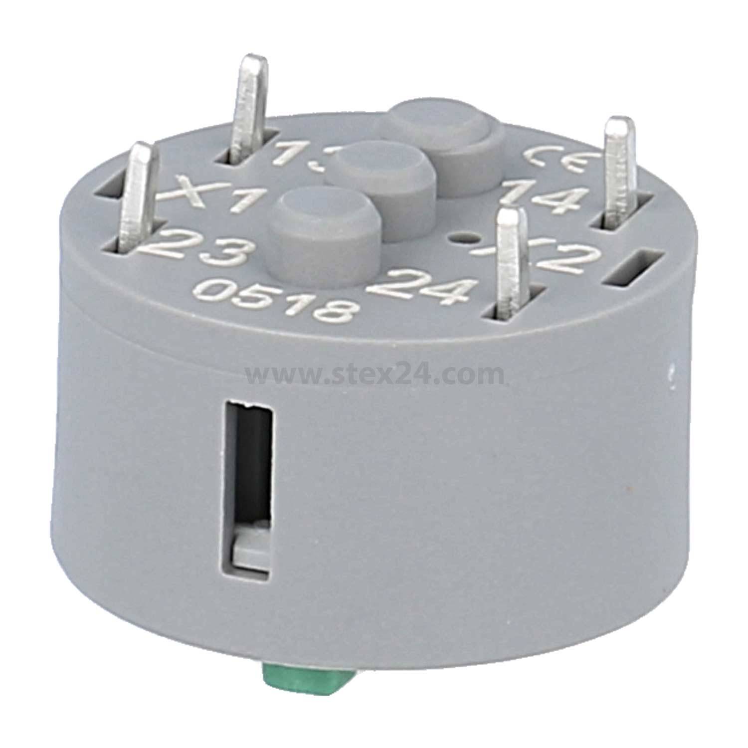 Eine graue zylindrische elektronische Komponente mit Pins und den Beschriftungen 'X1', '23', '14', '24', '0518'. Es scheint sich um ein Relais oder einen Anschluss zu handeln.