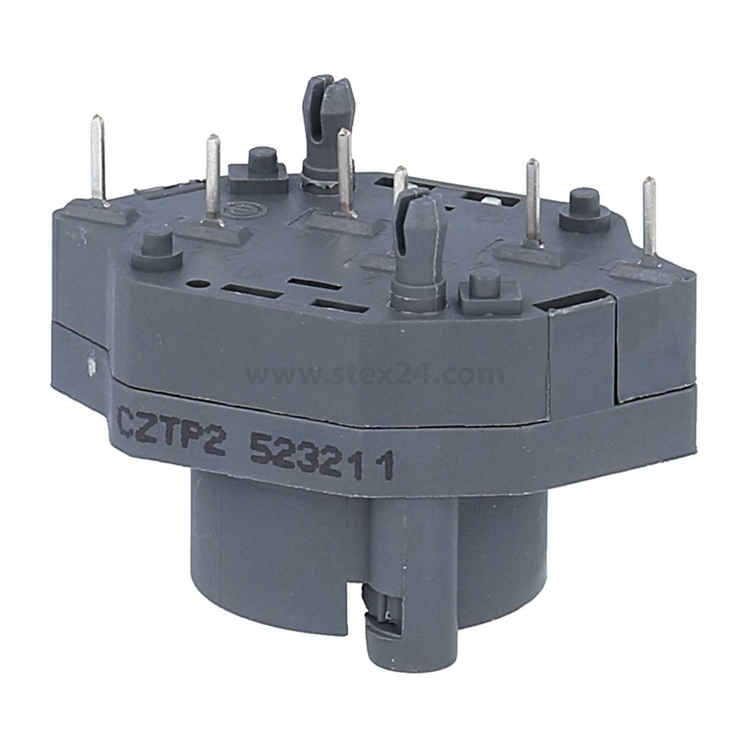 Eine graue elektrische Komponente mit mehreren Anschlüssen, beschriftet mit 