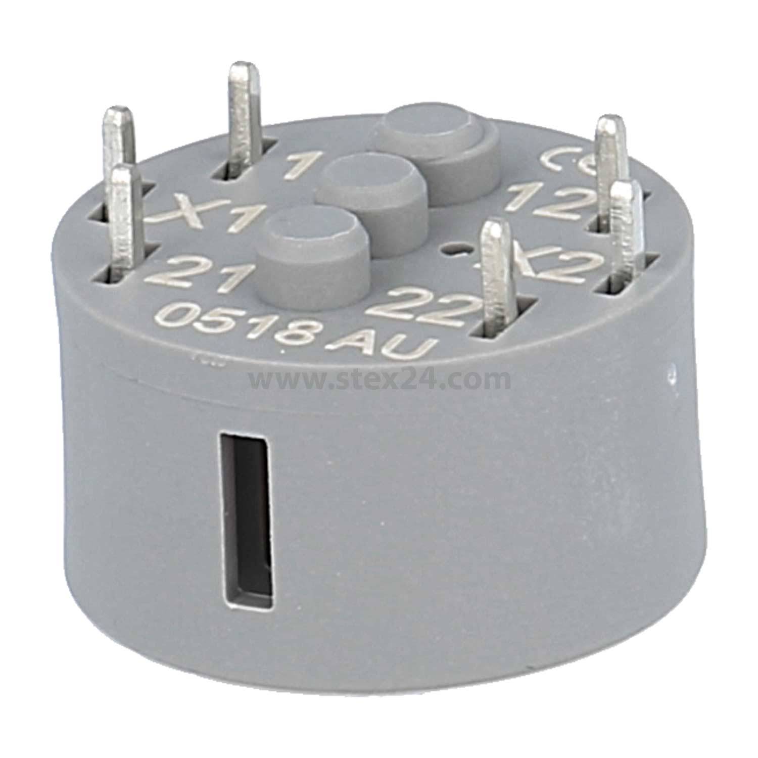 Eine kleine, runde, graue elektrische Komponente mit sechs Metallstiften an der Oberseite, beschriftet mit Zahlen und Buchstaben.