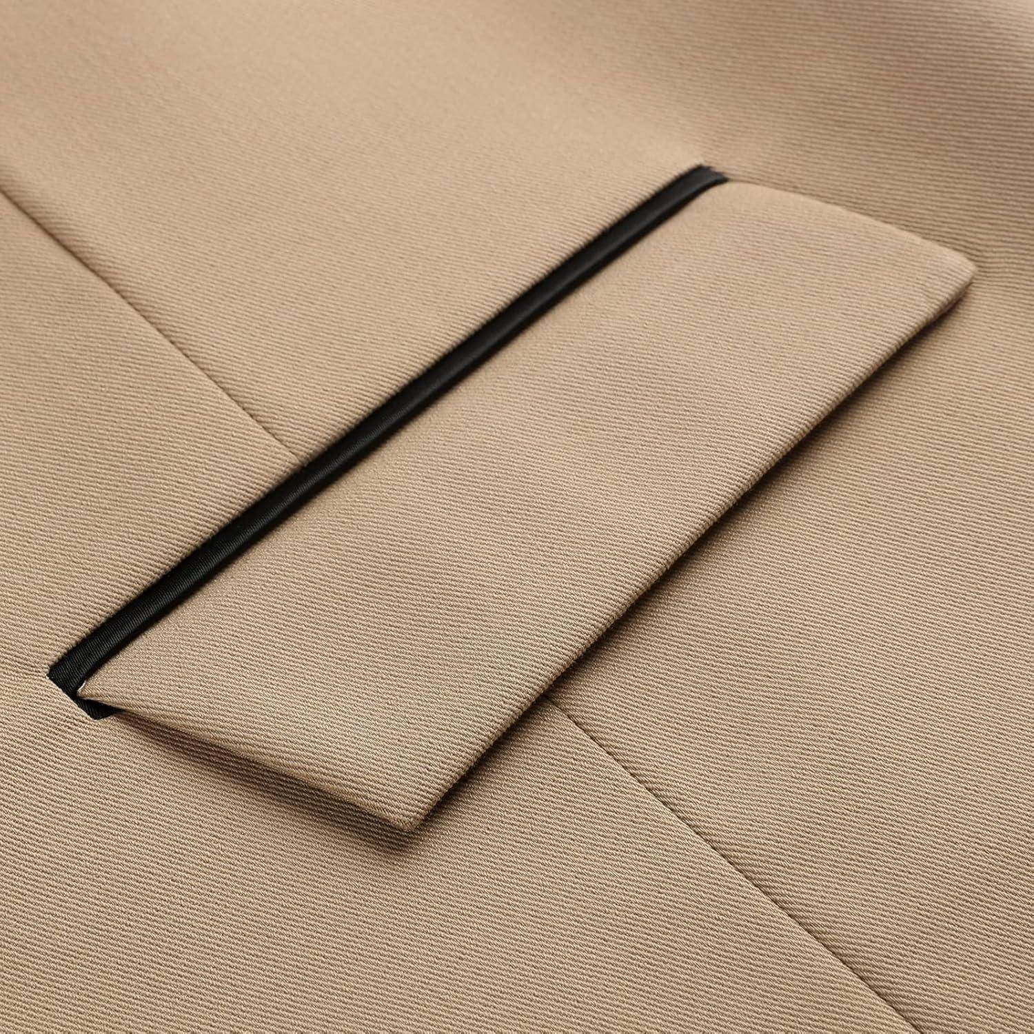 Eine Nahaufnahme der Tasche einer beigen maßgeschneiderten Jacke mit schwarzem Besatz, die die Textur und präzise Nahtführung des Stoffs zeigt.