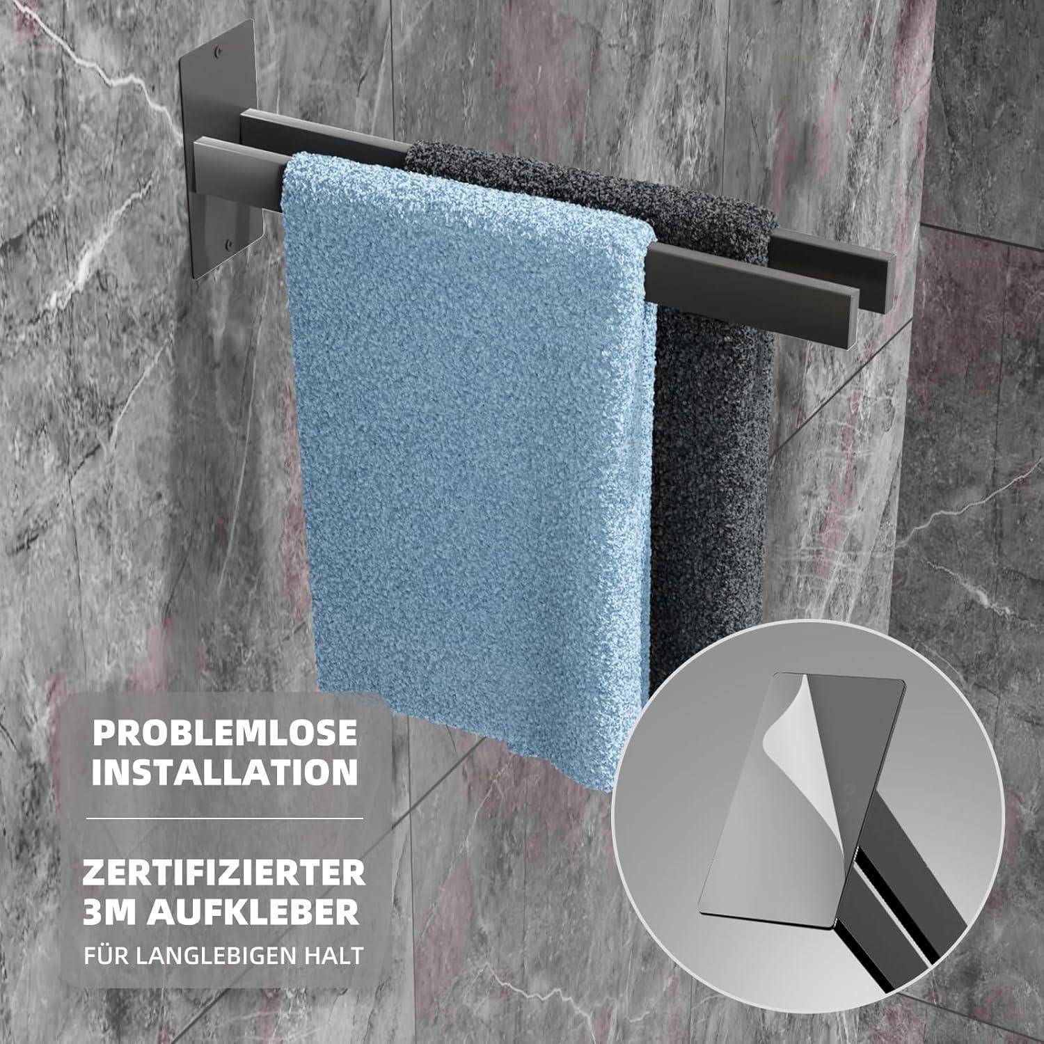 Ein Handtuchhalter mit schwarzen und blauen Handtüchern an einer Steinwand, mit einem Einschub, der den '3M-Aufkleber' für eine einfache Installation zeigt.