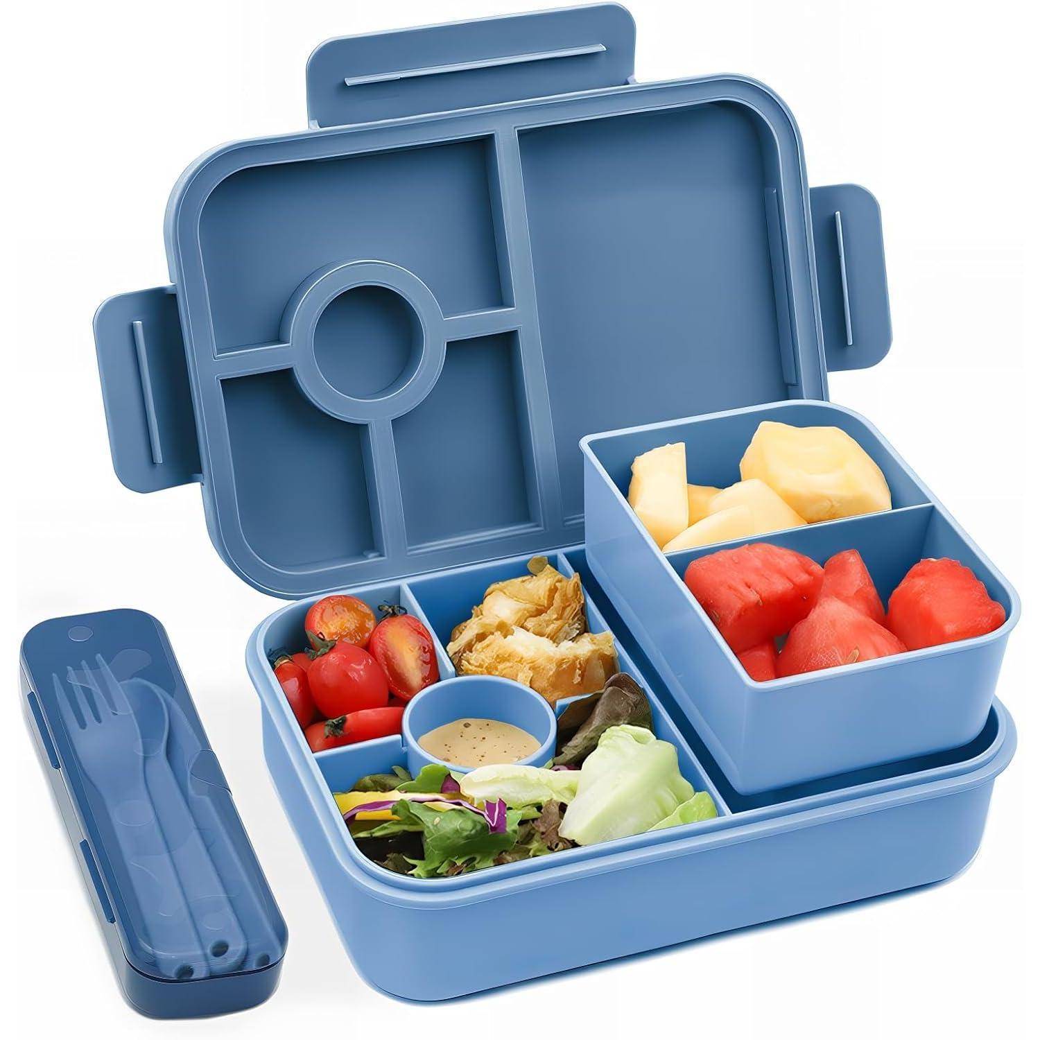 Eine blaue, in Fächer unterteilte Lunchbox mit frischem Gemüse, Obst, einem Fleischbereich und einer Dipsauce, neben einem Besteckset.