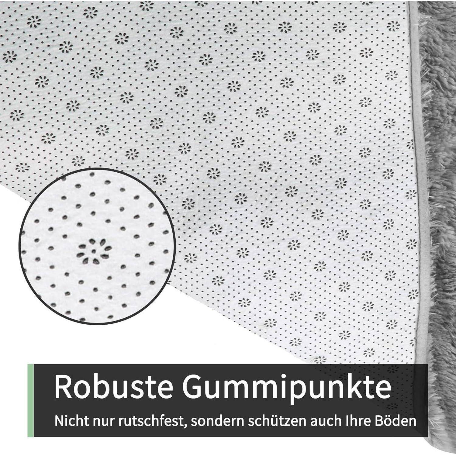 Weißer Stoff mit grauen Sprenkeln und durchgehender grauer Einfassung. Kreisförmiger Einsatz hebt kleine Gummipunkte hervor. Text liest sich 'Robuste Gummipunkte'.