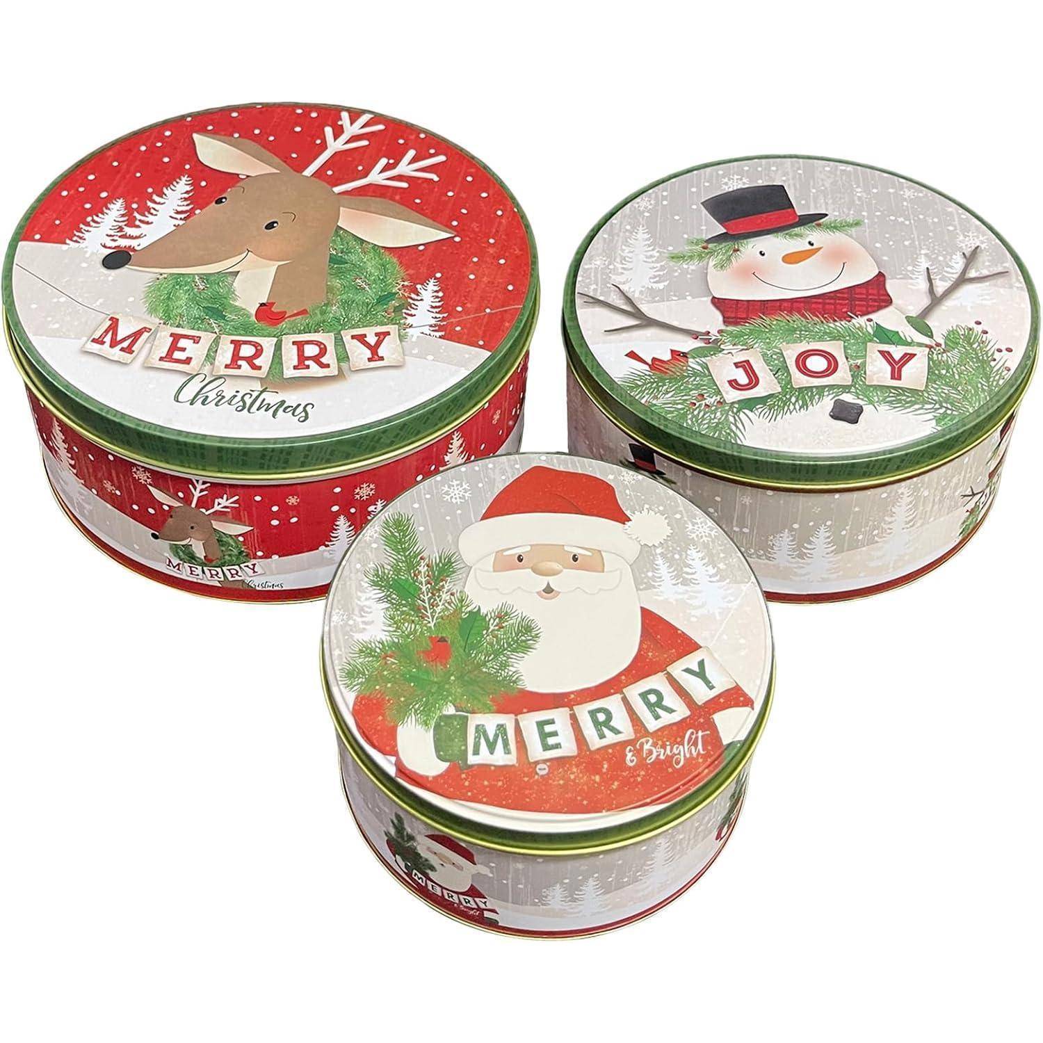 Drei festliche Dosen mit Weihnachtsmotiven: ein Rentier mit der Aufschrift „Frohe Weihnachten