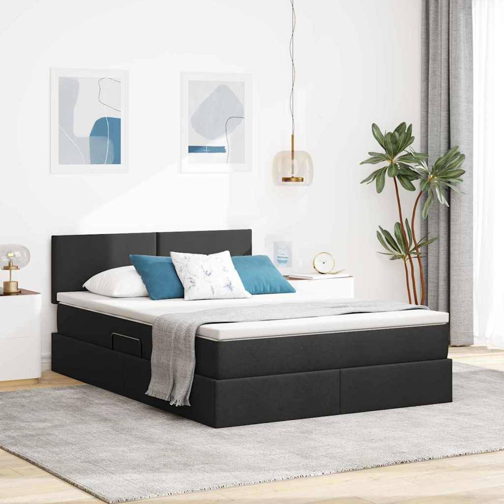 Ein modernes Schlafzimmer zeigt ein schwarzes Bett mit einer weißen Matratze und blauen und weißen Kissen. Zwei abstrakte Kunstwerke hängen über dem Bett.
