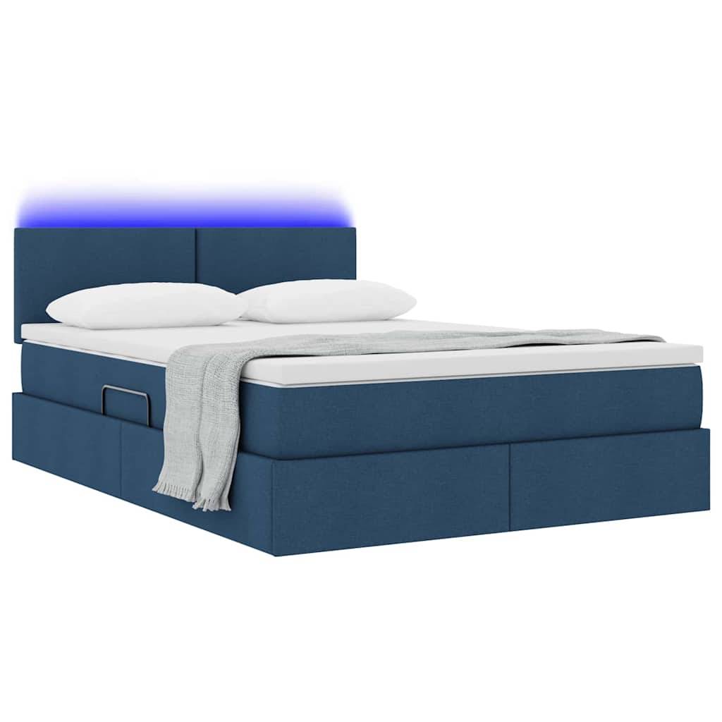 Ein modernes blaues Bett mit einer weißen Matratze und Kissen, ausgestattet mit einer grauen Wurfdecke und einem Kopfteil, das von einem blauen Licht beleuchtet wird.