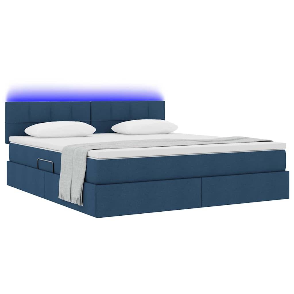 Ein modernes blaues Bett mit weißen Kissen und einer Decke. Das Kopfteil hat ein blaues LED-Licht, das eine ruhige Atmosphäre schafft.