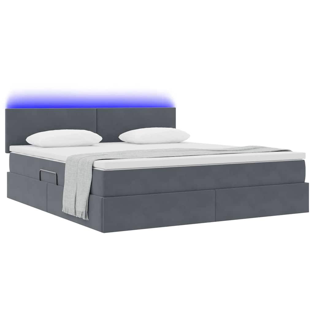 Ein modernes Bett mit gepolstertem Kopfteil und blauer LED-Beleuchtung, ausgestattet mit einer weißen Matratze, zwei Kissen und einer sorgfältig zusammengelegten hellgrauen Decke.