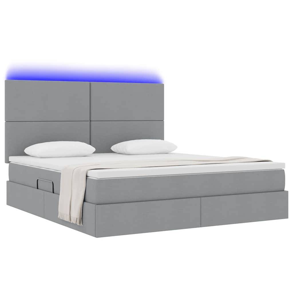 Ein modernes graues Bett mit gepolstertem Kopfteil, blauer LED-Beleuchtung und einer hellbeigen Decke, ausgestattet mit integrierten Seitenschubladen.