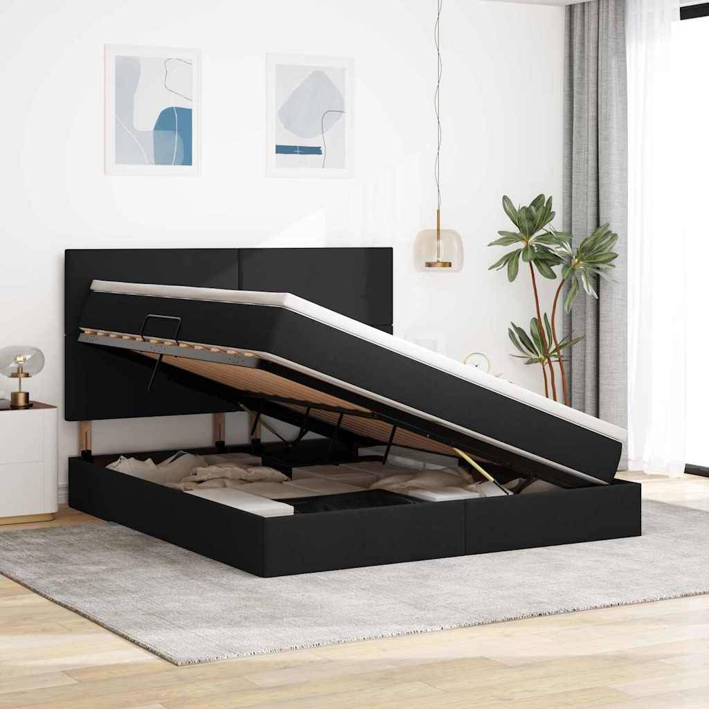 Bett mit schwarzer Hubstaumasis in einem modernen Schlafzimmer, mit hellgrauen Wänden, zwei abstrakten gerahmten Kunstwerken und einer Topfpflanze.