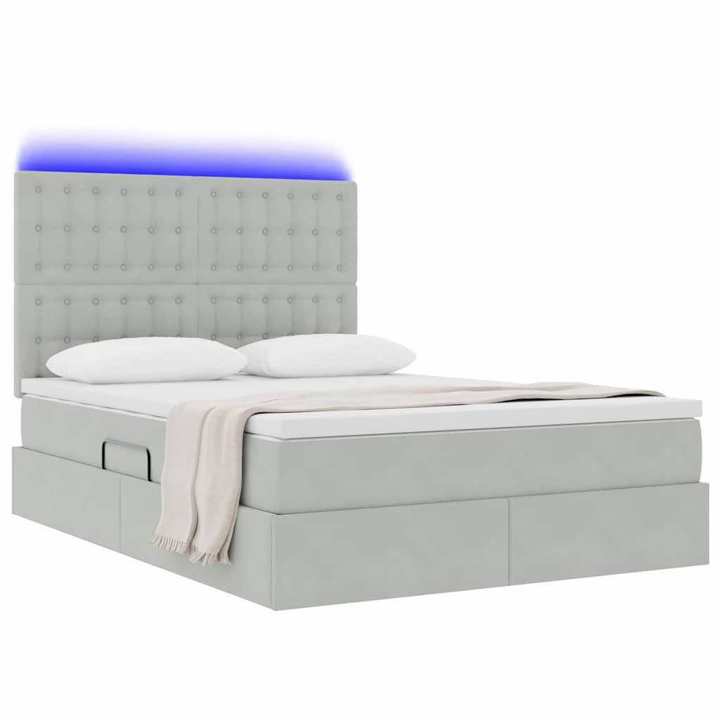 Ein modernes Bett mit gepolstertem Kopfteil, Schubladen unter dem Bett und einer weichen beigefarbenen Decke. Ein weiches blaues Licht ist über dem Kopfteil sichtbar.