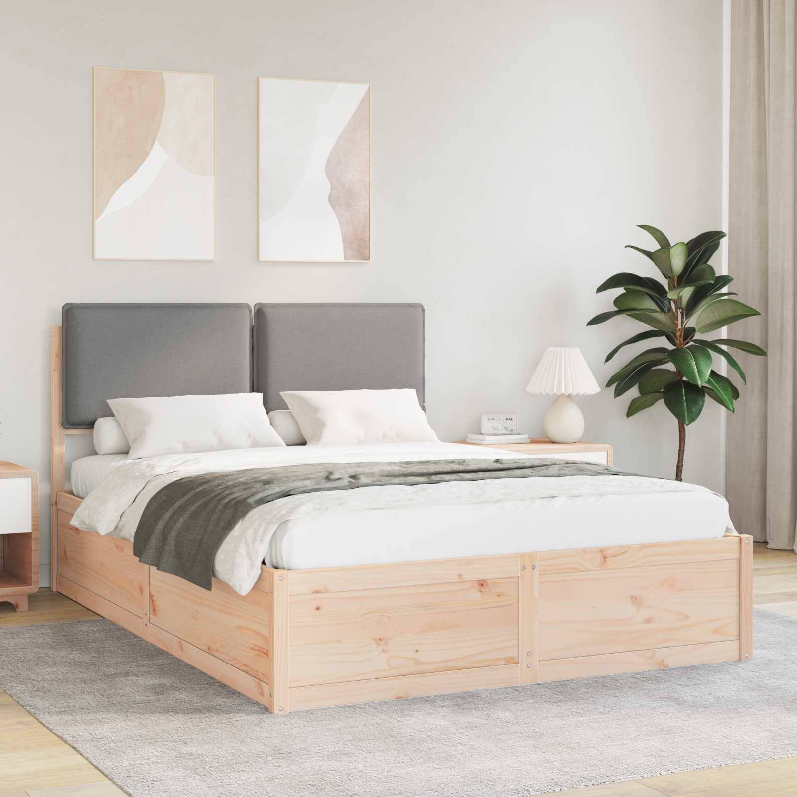 Ein aufgeräumtes Schlafzimmer mit einem Holzbett, das graue Kopfteile und eine grau-weiße Bettwäsche hat. Ein Nachttisch, eine Lampe, eine Pflanze und abstrakte Wandkunst sind zu sehen.