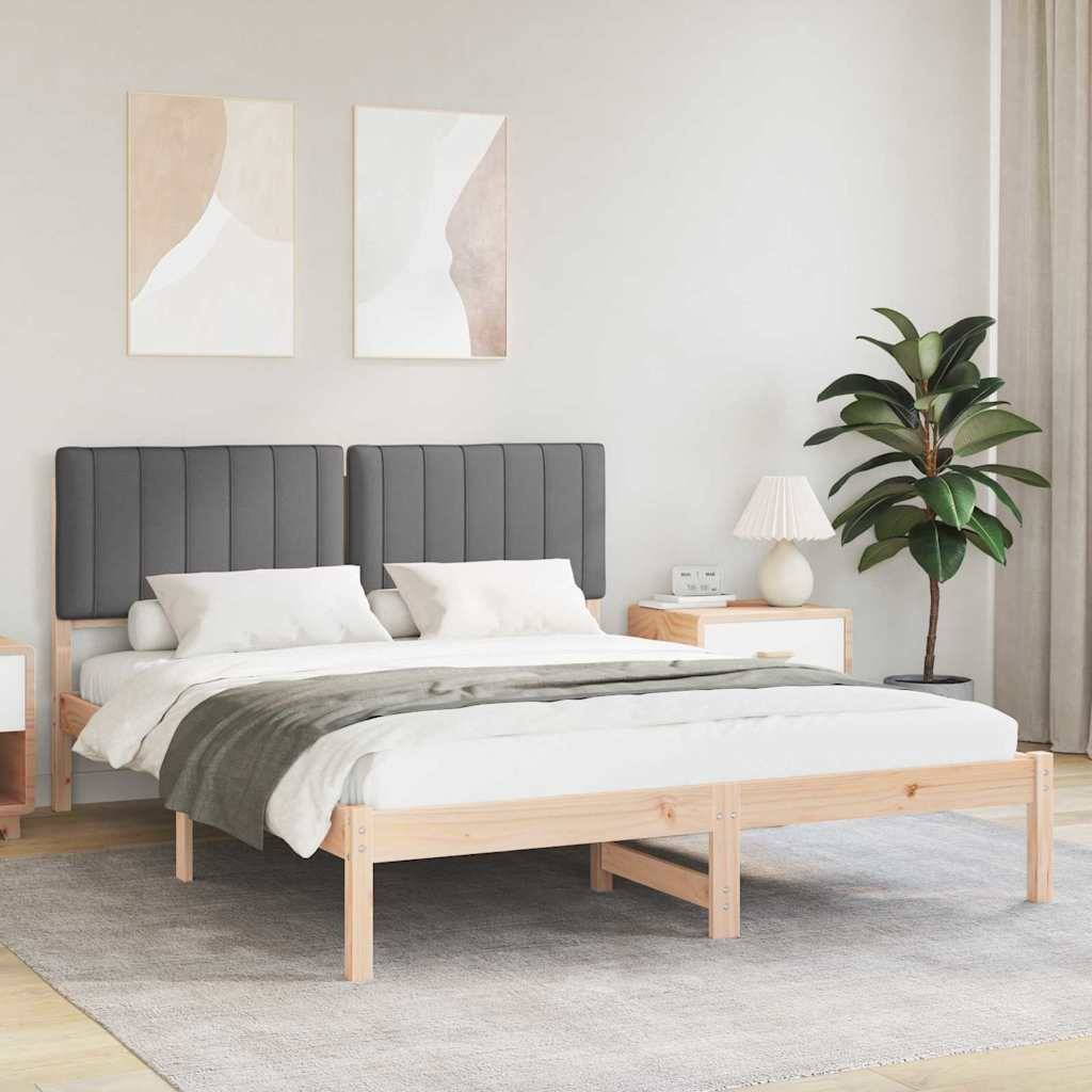 Ein modernes Schlafzimmer mit einem Bett aus hellem Holz, gepolstertem grauem Kopfteil und weißer Bettwäsche. Zwei abstrakte Kunstwerke und eine Pflanze dekorieren den Raum.