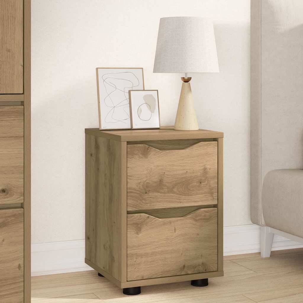 Ein Holz-Nachttisch mit zwei Schubladen, auf dem eine Lampe mit weißem Lampenschirm und zwei minimalistische gerahmte Kunstwerke stehen, befindet sich neben einem Bett.