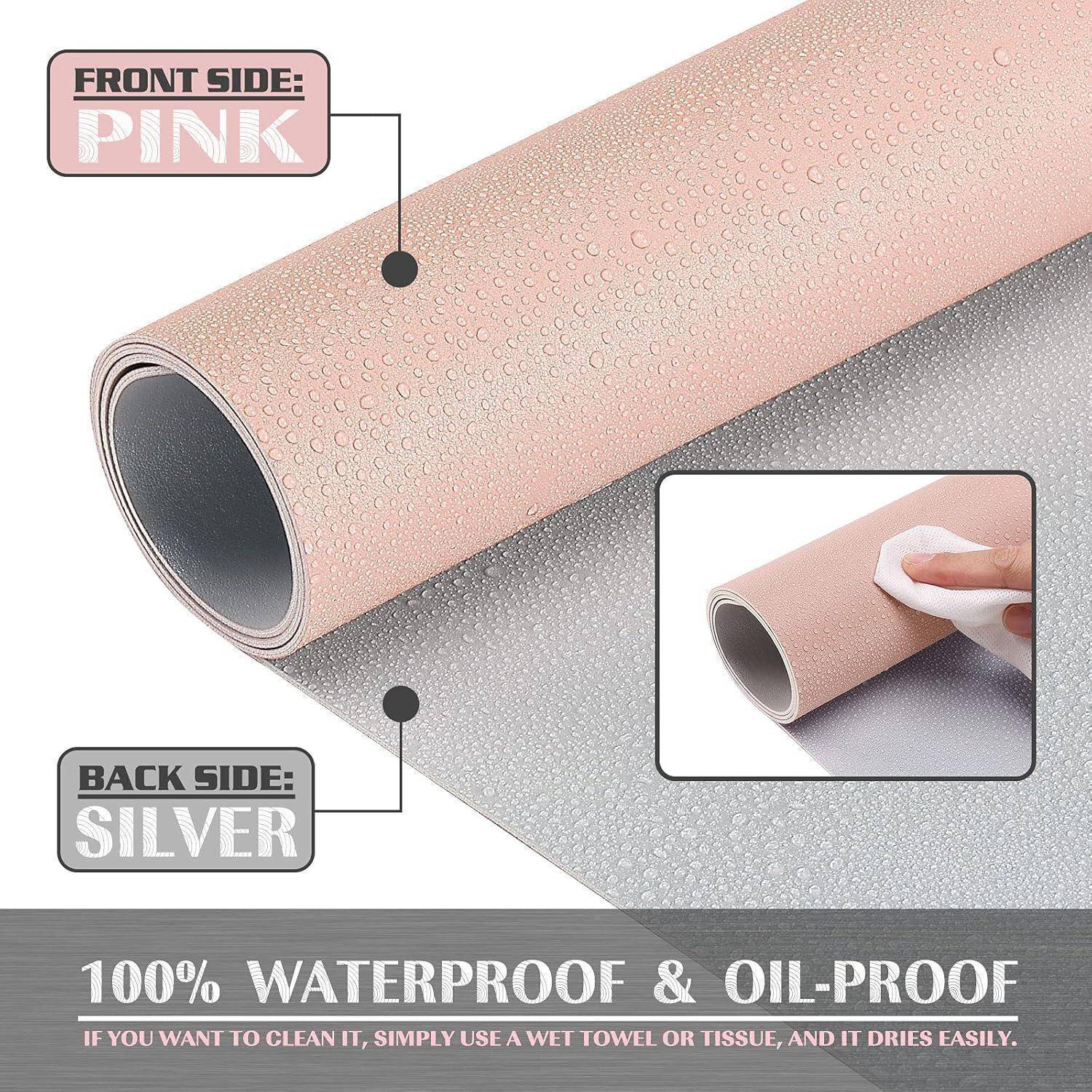 Eine Rolle aus beidseitigem wasserdichtem und ölabweisendem Material; Vorderseite ist pink, Rückseite ist silber. Text lautet: '100% Wasserdicht & Ölabweisend'.