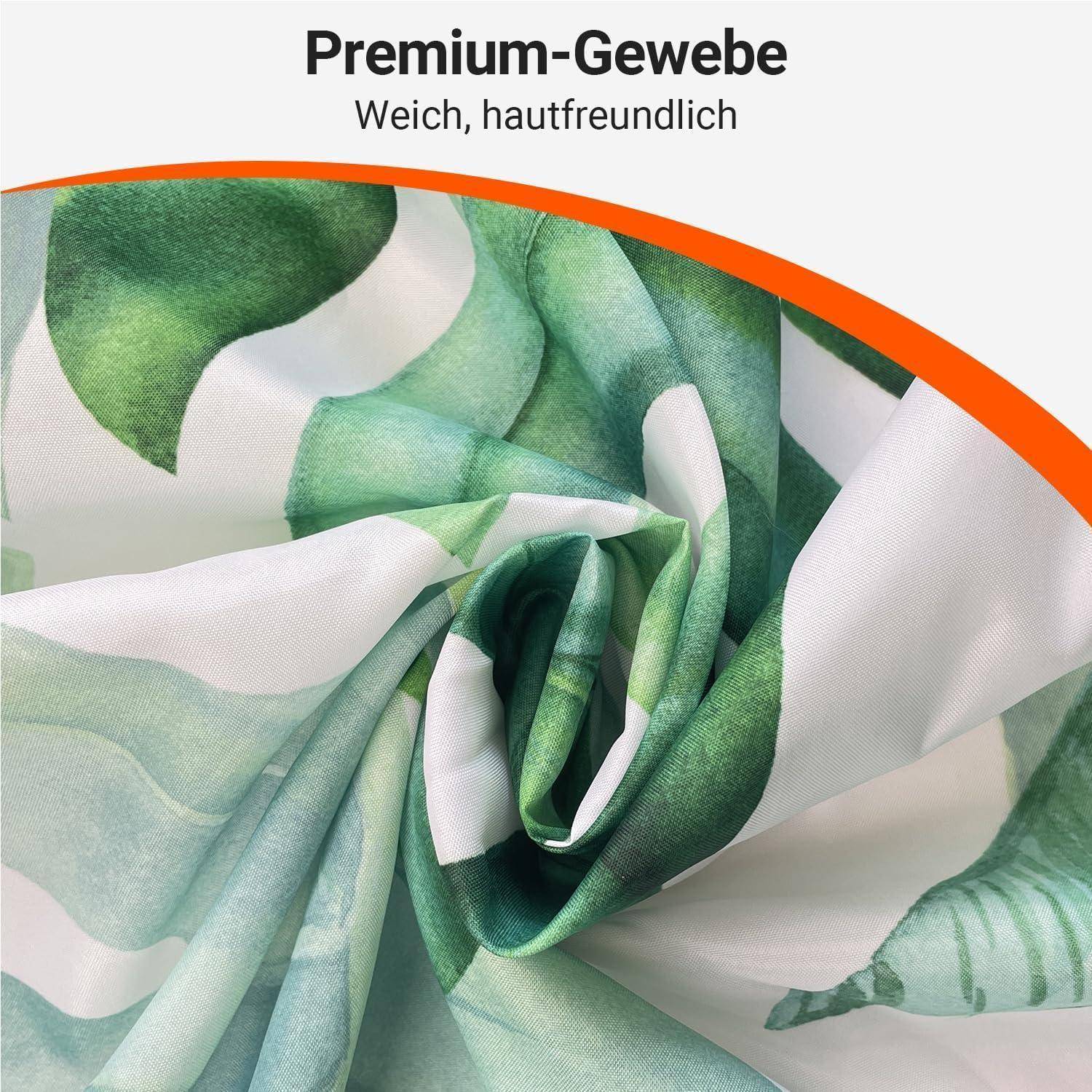 Eine Nahaufnahme von weichem Stoff mit einem grünen Blattmuster. Text oben liest sich: 'Premium-Gewebe Weich, hautfreundlich.