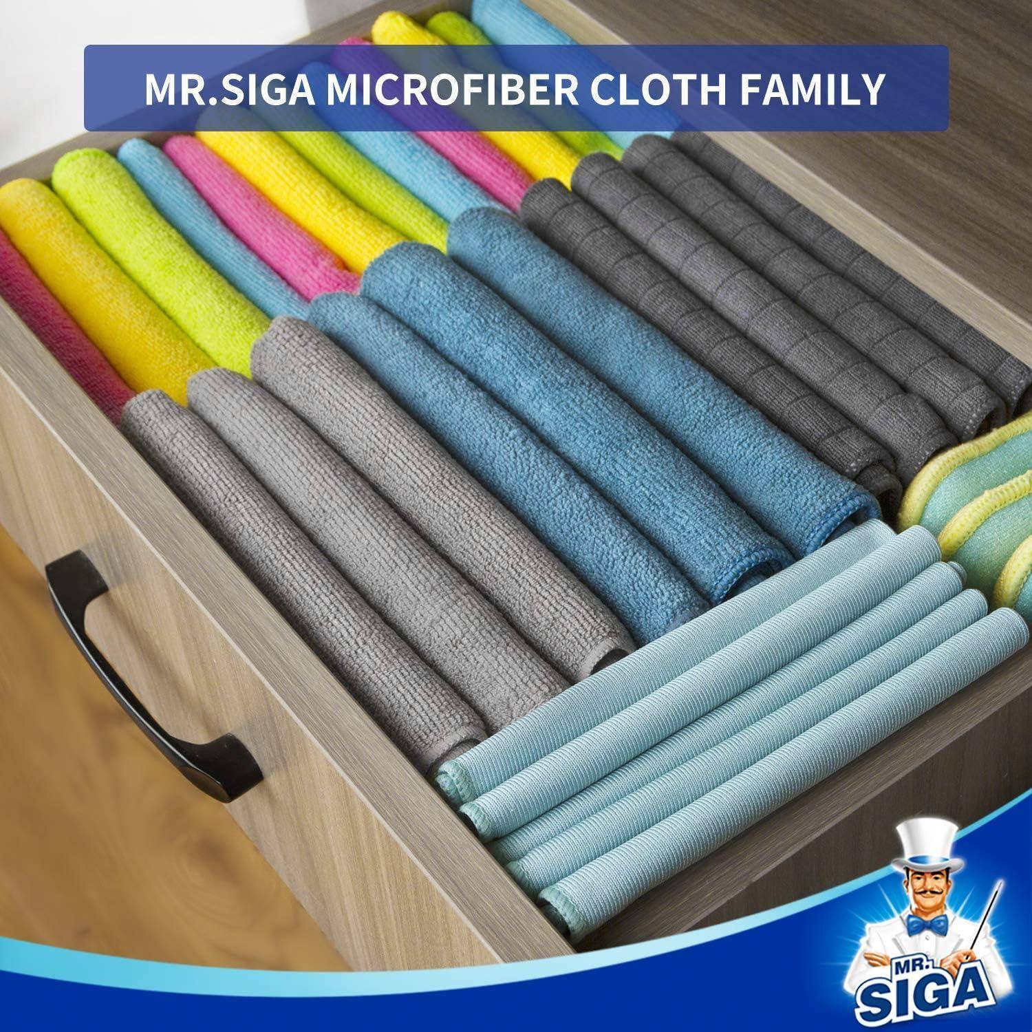 Eine Schublade gefüllt mit sorgfältig angeordneten Mikrofasertüchern in verschiedenen Farben. Ein Schild darüber liest: 'MR.SIGA Mikrofasertuch-Familie'.