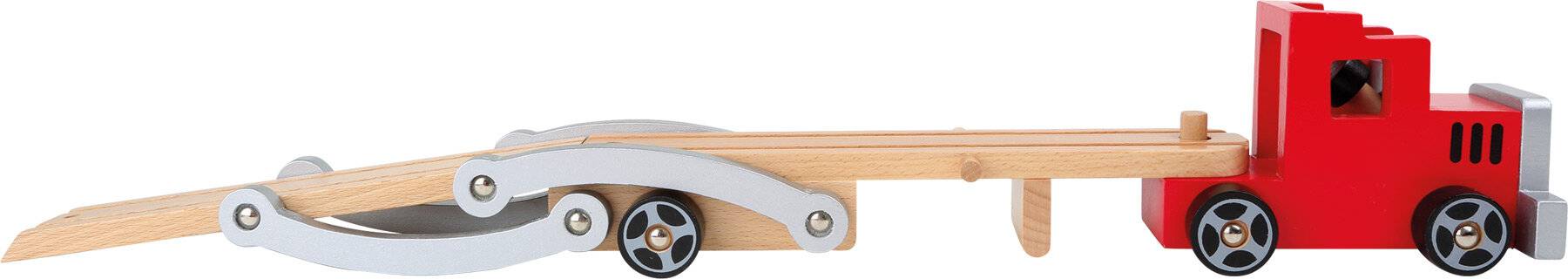 Nahaufnahme eines Holzobjekts mit einem Metallarm und einem kleinen Rad, möglicherweise Teil eines mechanischen Geräts oder eines Möbelstücks.