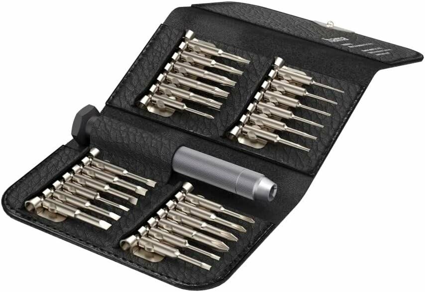 Ein schwarzer Lederkoffer für Werkzeuge, der verschiedene Metallschraubendreher-Bits und einen Griff enthält, ordentlich in Reihen angeordnet, für präzise Reparaturen.