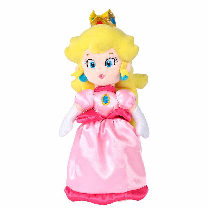 Eine Plüschfigur, die eine Figur in einem rosa Kleid und einer Krone mit blauen und roten Edelsteinen darstellt, steht aufrecht vor einem einfarbigen Hintergrund.